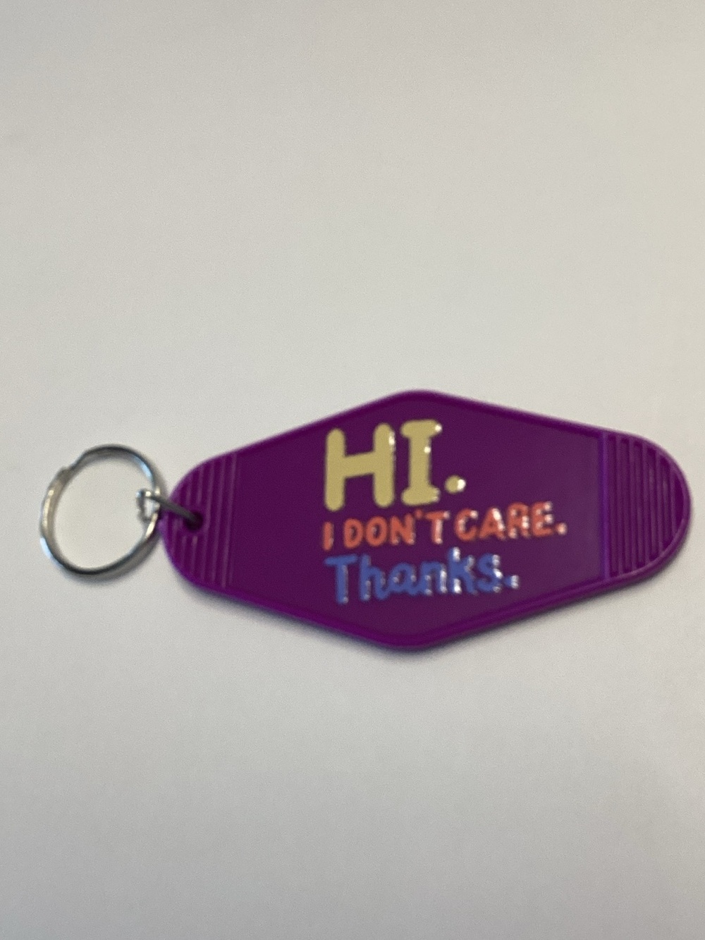 Purple Novelty Keychain with 'Hi. I Don't Care. Thanks.' Message